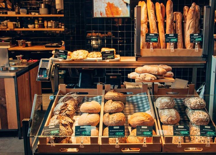 the front of a bakery stacked high with bread
