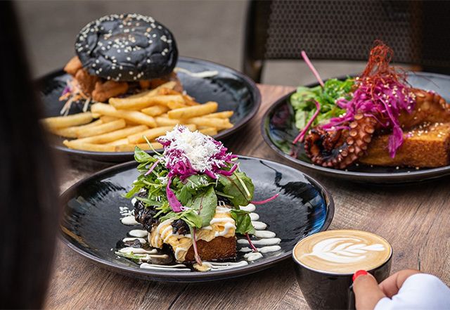 a table filled with breakfast meals and coffee